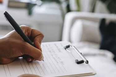 Writing with a pen on paper