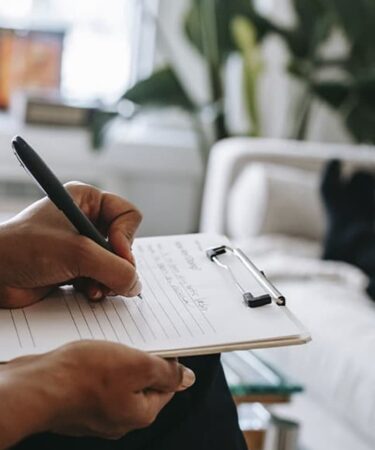 Writing with a pen on paper